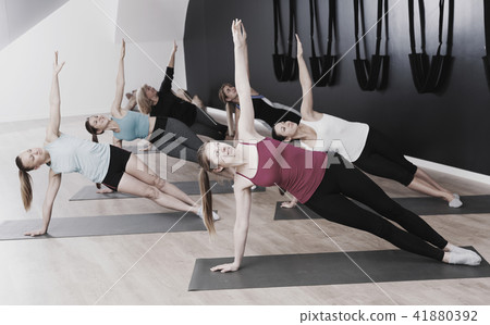 Females practicing yoga in studio 41880392