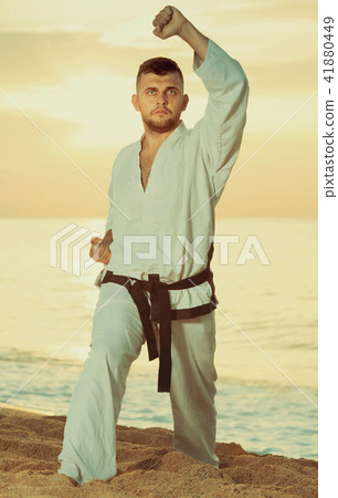 Adult guy practising karate kata poses 41880449