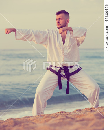 Young male practising karate kata poses Young male practising karate kata poses 41880496