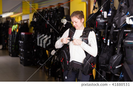 Young woman is trying new diving vest in store 41880531