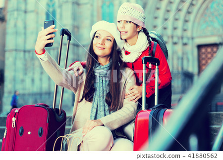 Cheerful woman with daughter making selfie 41880562