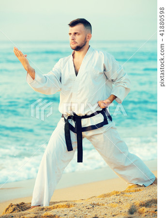 Active male practising karate kata poses Active male practising karate kata poses 41880598