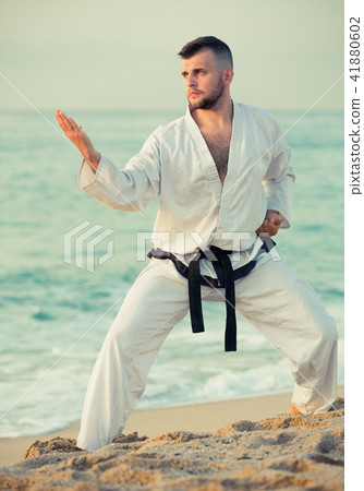 Ordinary male practising karate kata poses Ordinary male practising karate kata poses 41880602