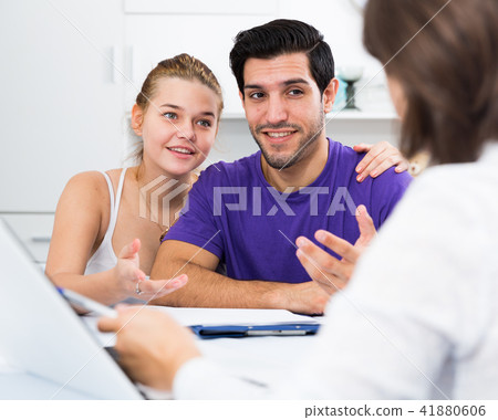 Loving couple with female designer at home Loving couple with female designer at home 41880606