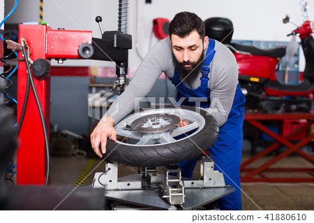 Man 20-30years old is working at restoring wheel Man 20-30years old is working at restoring wheel 41880610