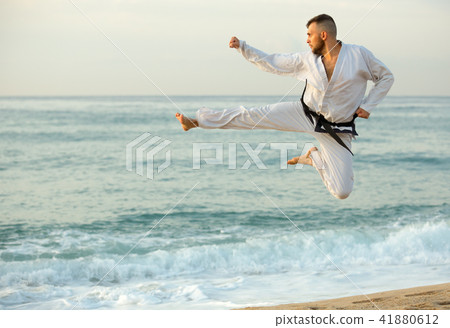 Adult man is training kick in jump 41880612