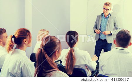 Nice male teacher lecturing to students Nice male teacher lecturing to students 41880657