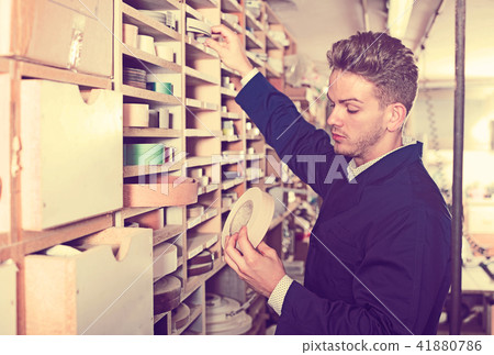 Man working with furniture edgebands 41880786