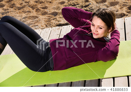 Young woman doing youga at beach Young woman doing youga at beach 41880833