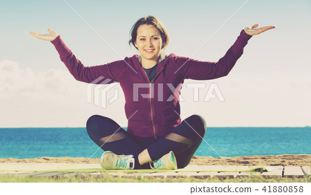 Young woman doing youga at beach 41880858