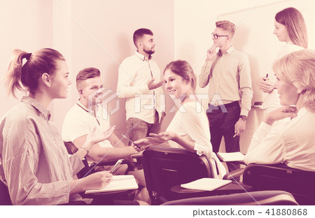 Group of students with teacher in break between lessons indoors 41880868