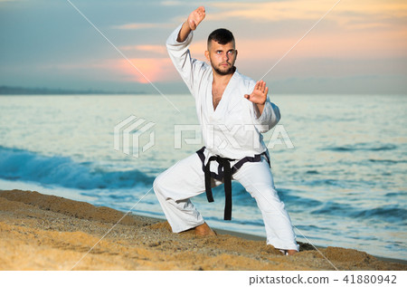 Active man doing karate at ocean quay Active man doing karate at ocean quay 41880942