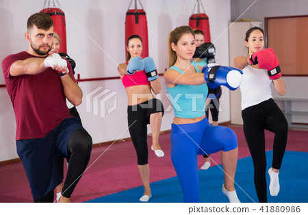 women with trainer are doing box exercises 41880986