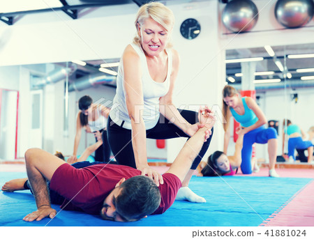 Mature female exercise self-defence moves with coach Mature female exercise self-defence moves with coach 41881024