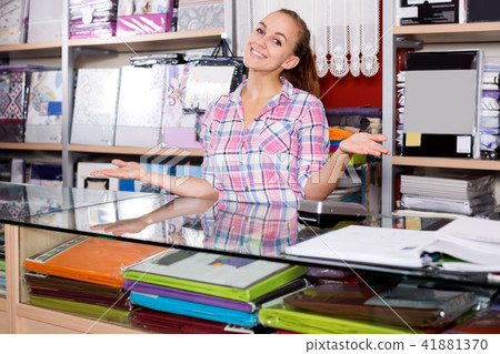 Woman seller looking helpful at counter 41881370