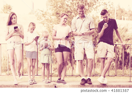 Young family with children looking at phone 41881387