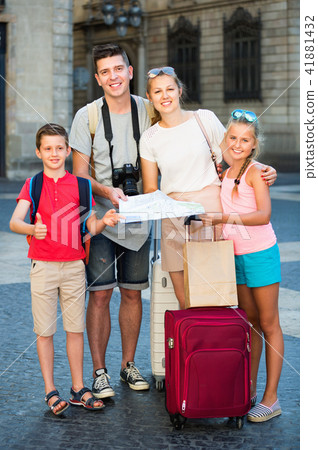 Parents with two kids traveling together searching location on paper map 41881432