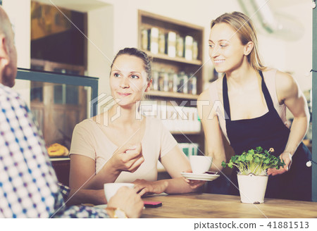 Middle aged man and young woman talking in cozy cafe 41881513