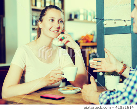 Cheerful young female talking with male Cheerful young female talking with male 41881614
