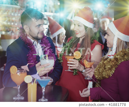 Guy with girls on new year eve party in bar Guy with girls on new year eve party in bar 41881778
