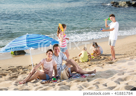 Portrait of glad man and woman resting on beach Portrait of glad man and woman resting on beach 41881784