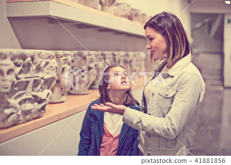 Ordinary mother and daughter looking at statues Ordinary mother and daughter looking at statues 41881856