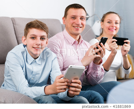 Parents and son using phones Parents and son using phones 41881869