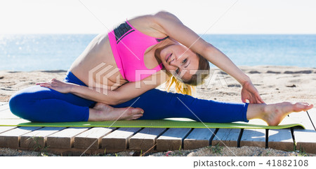 Fitness woman practicing set of stretching exercises Fitness woman practicing set of stretching exercises 41882108