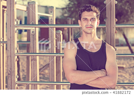 Man in sportswear near fitness station Man in sportswear near fitness station 41882172