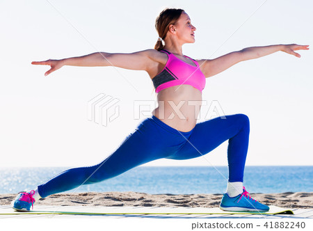 Adult female is practicing stretching Adult female is practicing stretching 41882240