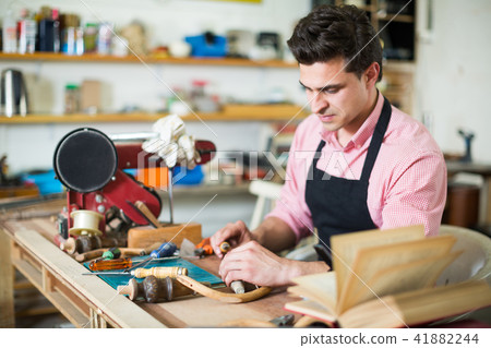 Craftsman in uniform working in carpentry 41882244