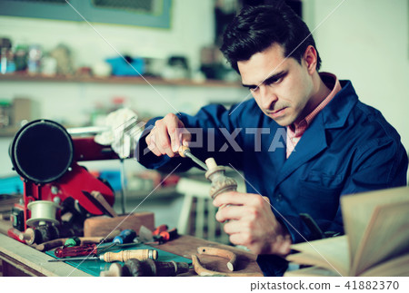 Craftsman in uniform working in carpentry 41882370
