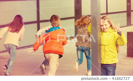 Group of happy children playing at Hide-and-seek Group of happy children playing at Hide-and-seek 41882727