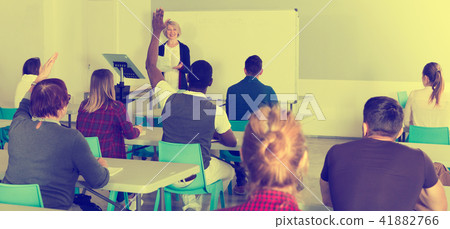 Students working with professor in auditorium 41882766