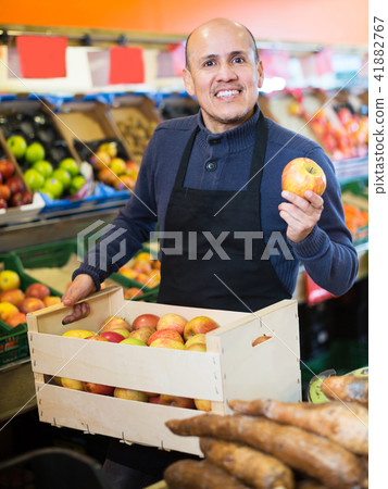 Salesman working in fruit section Salesman working in fruit section 41882767