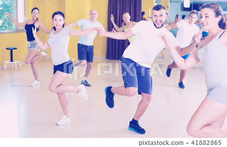 Happy men and women enjoying active dance Happy men and women enjoying active dance 41882865