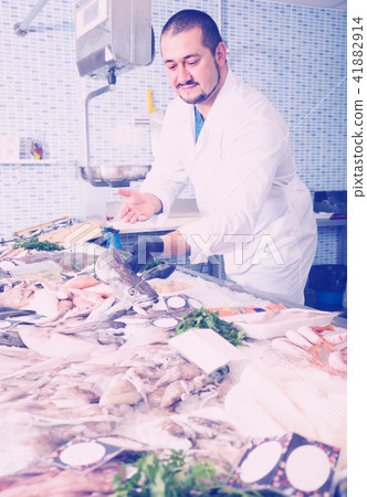 Seller holding fish Seller holding fish 41882914