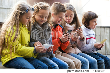 Children playing with mobile phones 41883080
