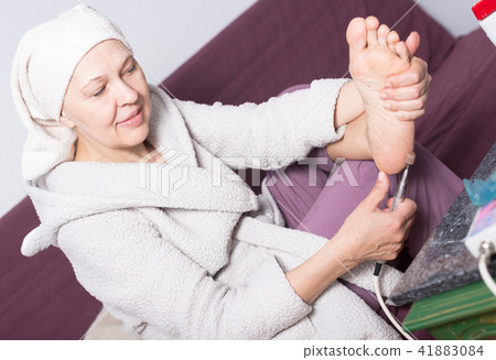 Woman doing pedicure Woman doing pedicure 41883084