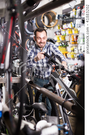 Cyclist is looking for bicycle handlebars Cyclist is looking for bicycle handlebars 41883202