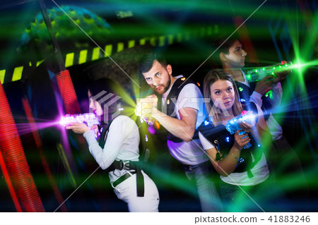 Young people playing laser tag in bright beams Young people playing laser tag in bright beams 41883246