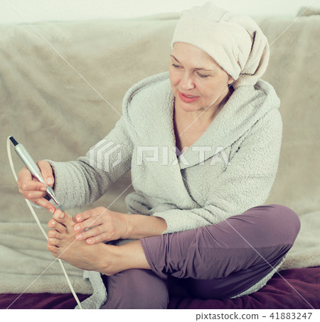 Woman doing pedicure Woman doing pedicure 41883247