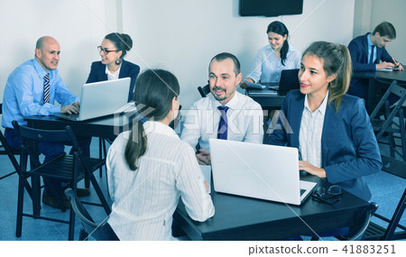 Coworkers working effectively on business project together Coworkers working effectively on business project together 41883251
