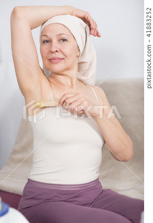 Woman doing body hair removal 41883252