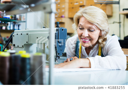 Tailor using sewing machine 41883255