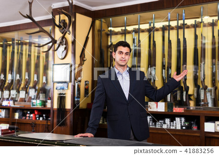 Salesman showing rifle Salesman showing rifle 41883256