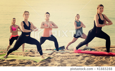 Glad sporty women practicing yoga positions 41883288