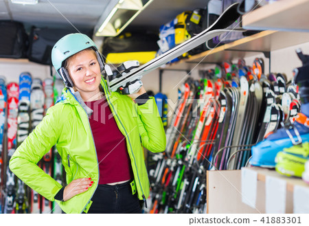 Portrait of customer woman in skki equipment who is demonstratin 41883301