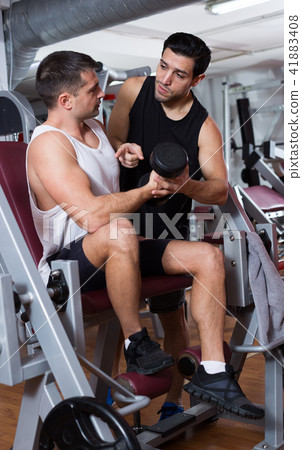 Man during training with instructor in gym Man during training with instructor in gym 41883408
