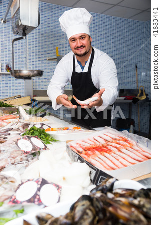Man in cap showing fish Man in cap showing fish 41883441